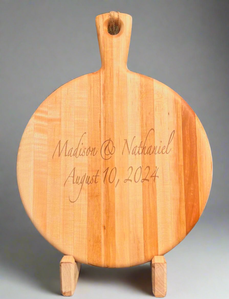 Laser-engraved charcuterie board with intricate custom designs, showcasing detailed craftsmanship and personalized touches