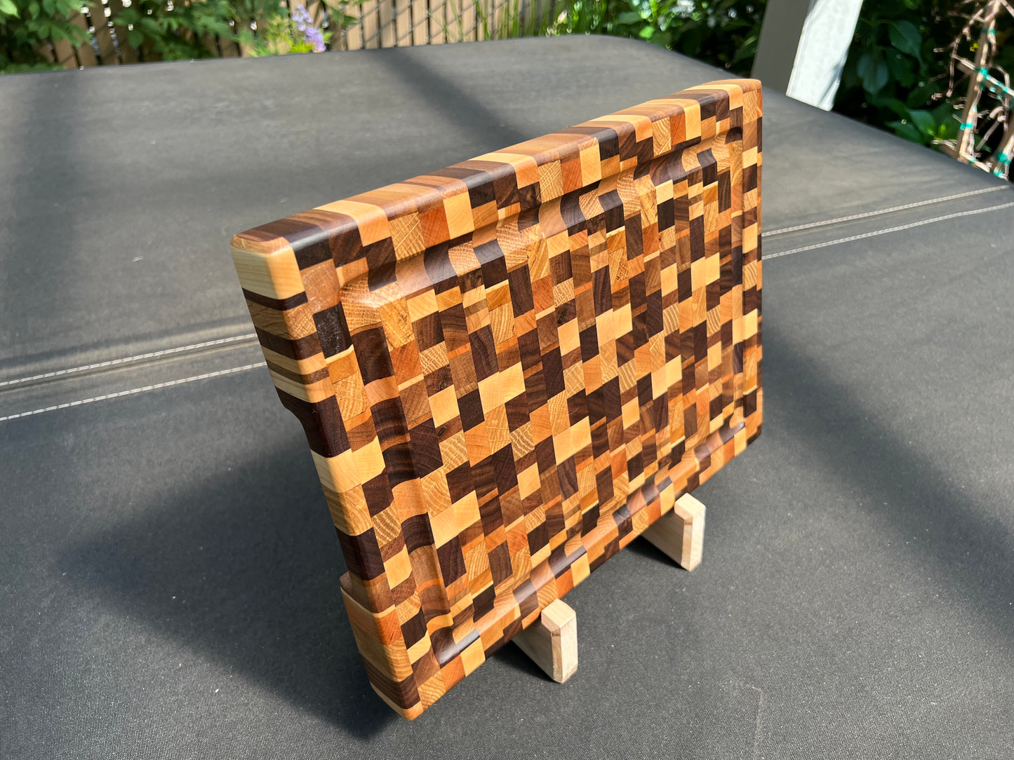 Chaotic end grain cutting board with a distinctive, dynamic pattern and a practical juice groove, crafted for both style and functionality