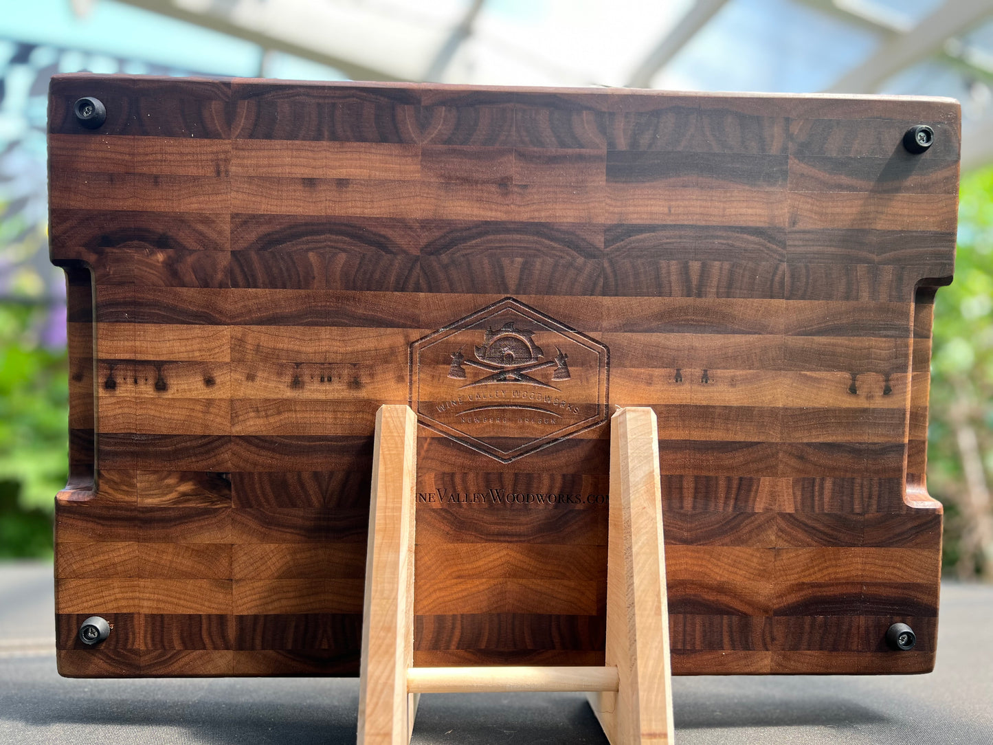 Large end grain walnut cutting board with a robust, textured surface that highlights the rich wood grain and provides durability for heavy use.