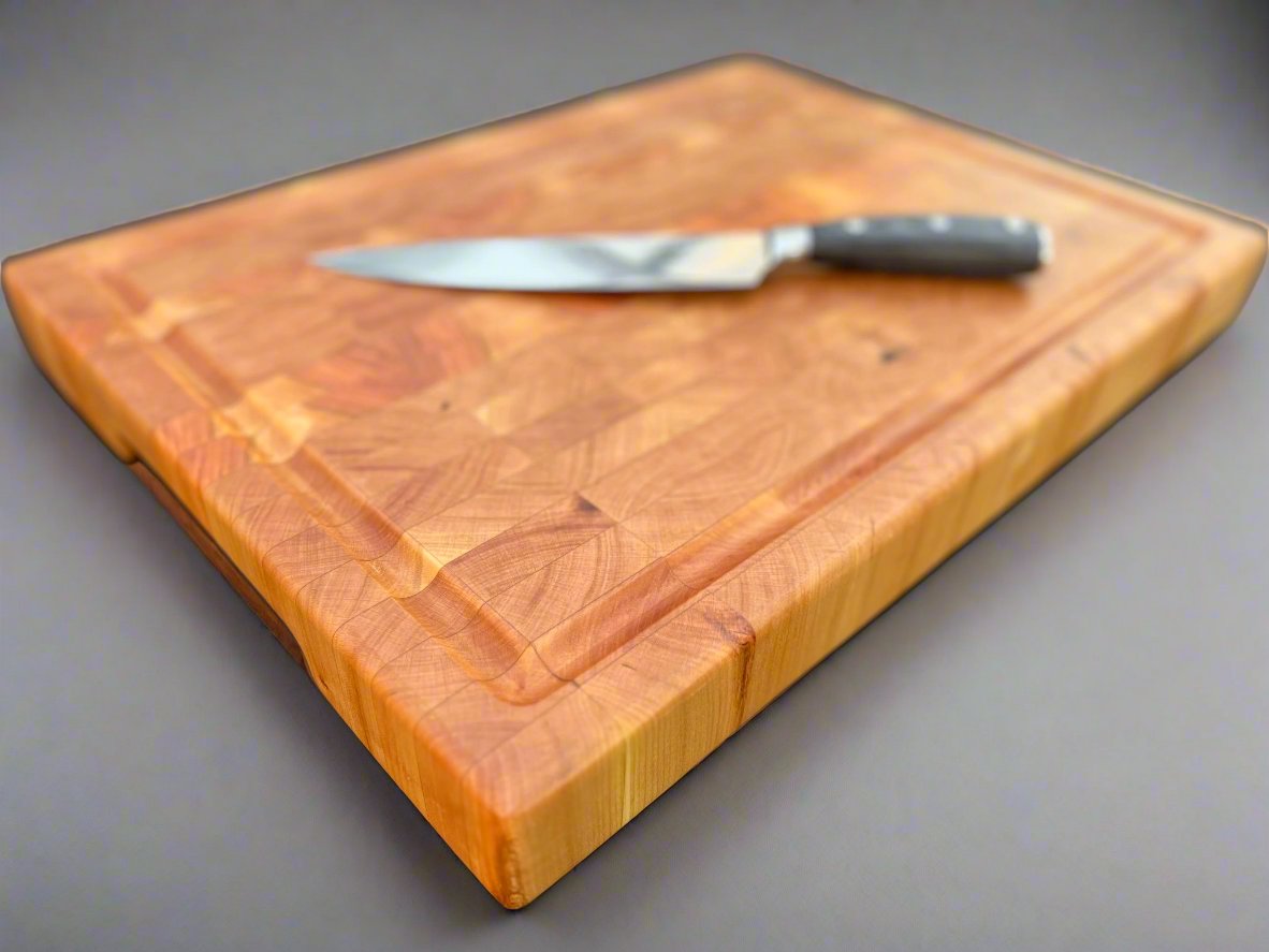 Cherry cutting board with a smooth, rich finish, highlighting the wood's natural warmth and grain pattern.