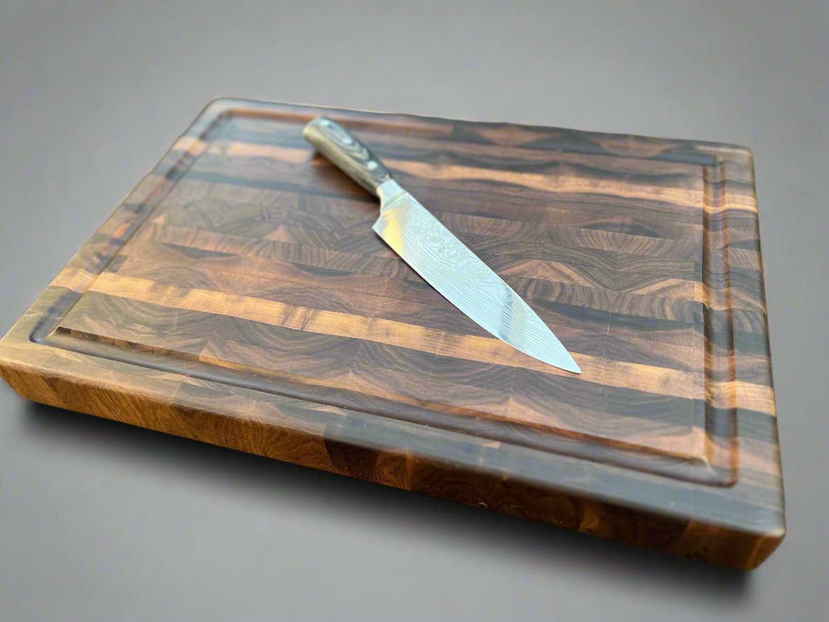 Walnut cutting board featuring a dark, elegant finish and rich wood grain, ideal for stylish and durable kitchen use.