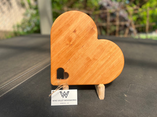 Heart-shaped charcuterie board made from premium wood, featuring a unique and charming design perfect for serving cheeses, meats, and appetizers.