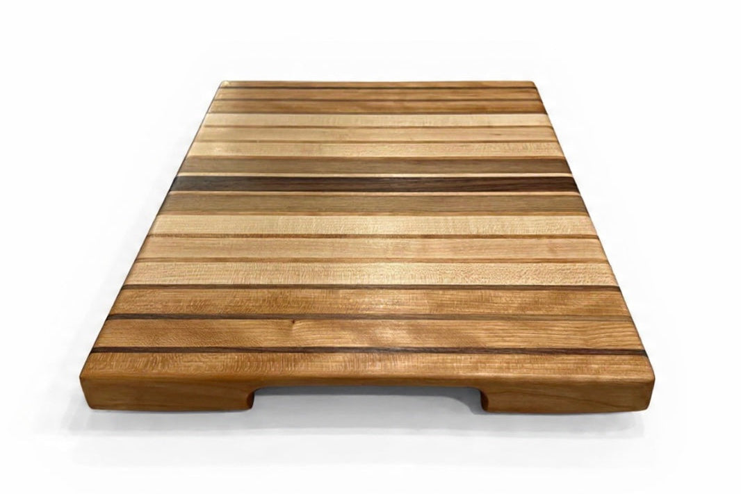 Wooden cutting board with slatted design on a white background