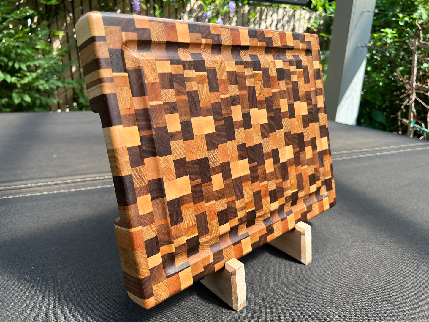 Chaotic end grain cutting board with a distinctive, dynamic pattern and a practical juice groove, crafted for both style and functionality