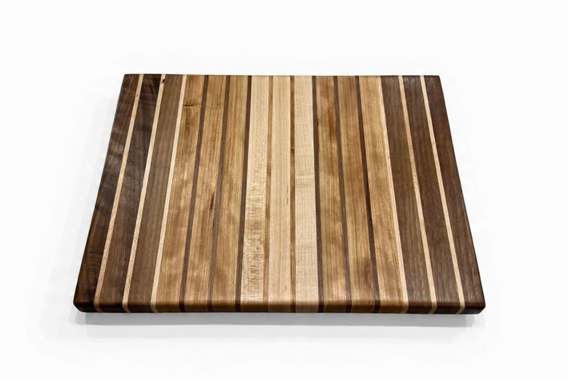 Wooden cutting board with striped pattern on a white background
